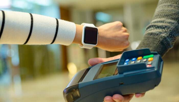 Customer using smart watch to pay by NFC technology